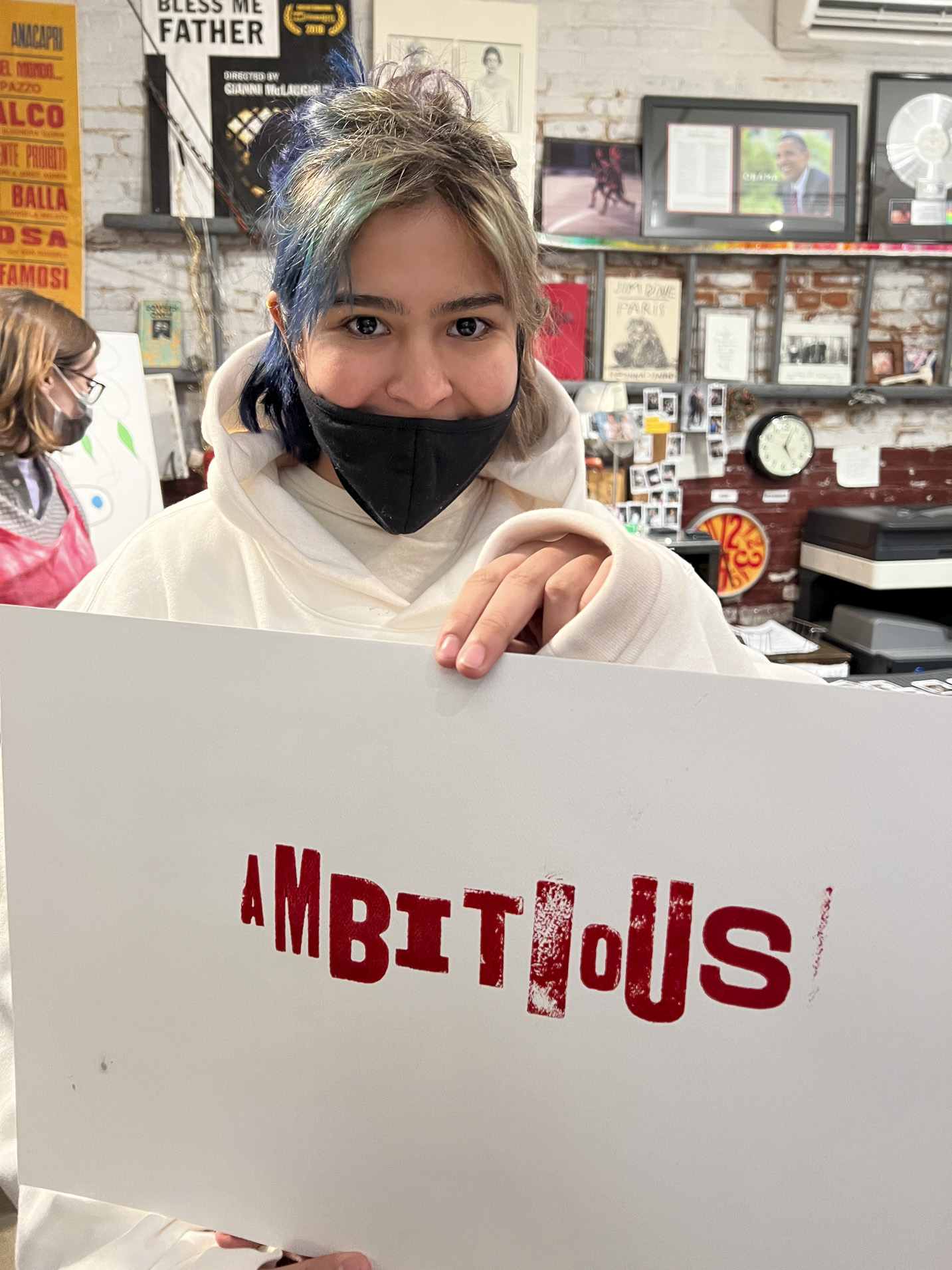 Tisch student holding a print made with hand-set type